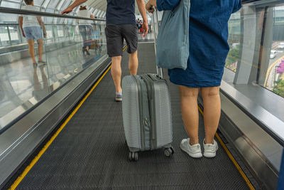 Low section of people walking on railway station platform