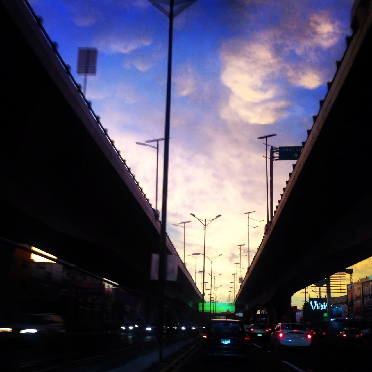 LOW ANGLE VIEW OF TRAFFIC ON ROAD AGAINST SKY