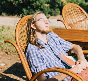 Young man sitting on chair