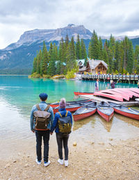 Rear view of people in boat on lake