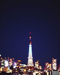 Low angle view of illuminated tower at night