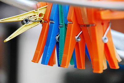 Close-up of multi colored clothespins hanging on clothesline