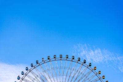 Low angle view of ferris wheel against sky