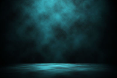 Low angle view of illuminated blue sky at night