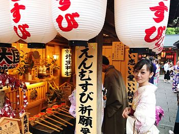 Portrait of mid adult woman standing at market stall