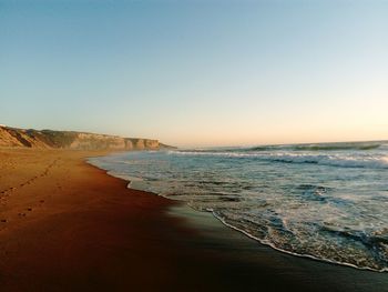 Scenic view of beach against clear sky