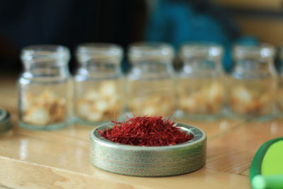 Close-up of strawberries in glass container on table