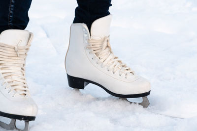 Woman skating at ice. close up of feet with ice skates on