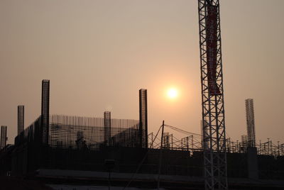 Metallic structure against sky during sunset