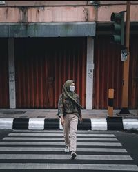 Rear view of woman walking on staircase of building