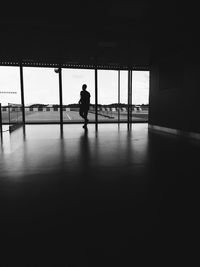 Silhouette of man walking in airport