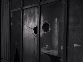 Damaged window of abandoned house