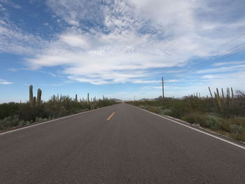 Country road against sky