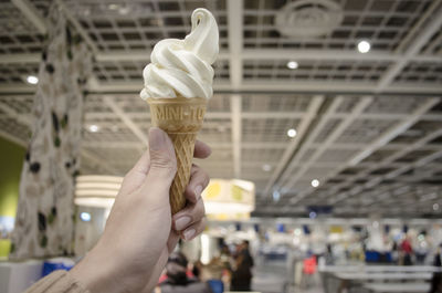 Cropped hand holding ice cream cone