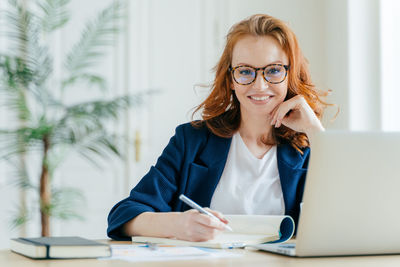 Portrait of businesswoman working at desk in office