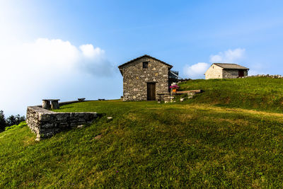 Stone shelter among the green meadows on the mountains above revine lago treviso veneto italy