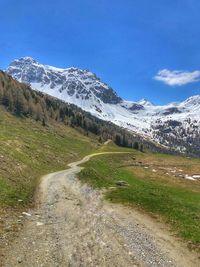 Scenic view of snowcapped mountains against blue sky