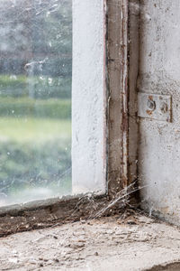 Close-up of wet window of building