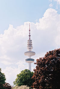 Low angle view of communications tower against sky