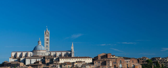 View of cityscape against blue sky