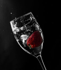 Close-up of drink on glass against black background