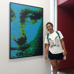 Portrait of smiling woman standing against wall