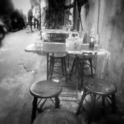 Empty chairs and tables at sidewalk cafe