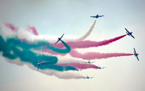 Low angle view of airshow against sky