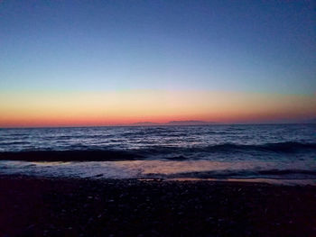 Scenic view of sea against clear sky during sunset