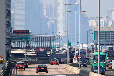 Traffic on road against buildings in city