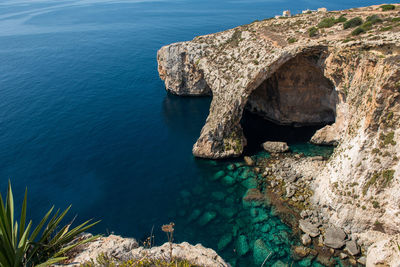 Blue grotto cave in malta. natural limestone arch over a lagoon