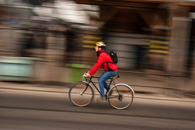 Blurred motion of man riding bicycle