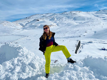 Full length of woman on snowcapped mountains during winter