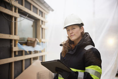 Female engineer using digital tablet at building site