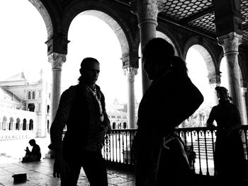 People standing at historic building