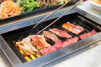 High angle view of meat on barbecue grill