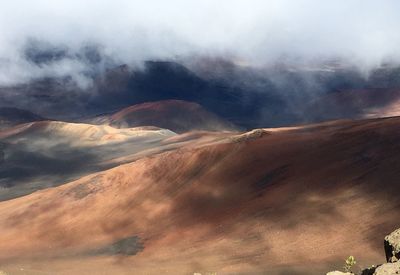 View of volcanic landscape against clouds