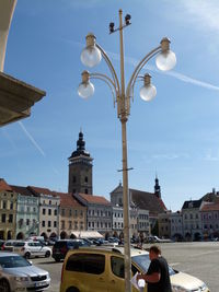 Street by buildings against sky in city