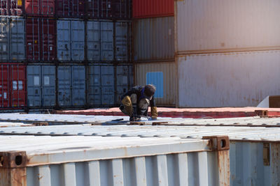 Low section of man standing in factory