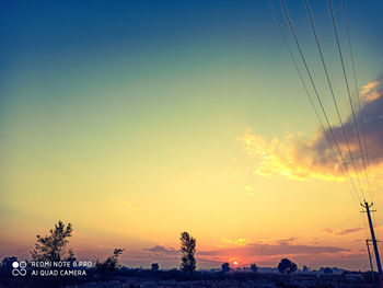 Silhouette trees against sky during sunset