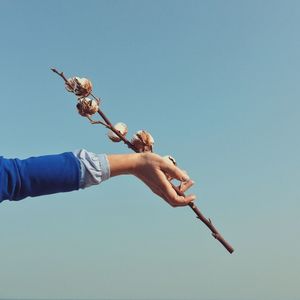 Low angle view of man against clear blue sky