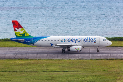 Airplane on runway by lake