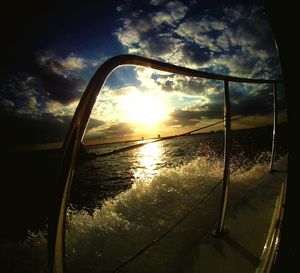 Scenic view of sea against cloudy sky at sunset