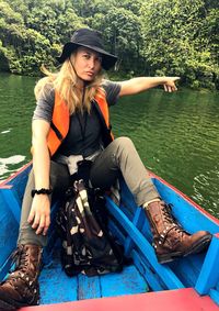 Portrait of female hiker traveling in boat on lake