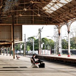 Businessman using cell phone on railway platform