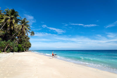 Scenic view of beach against blue sky