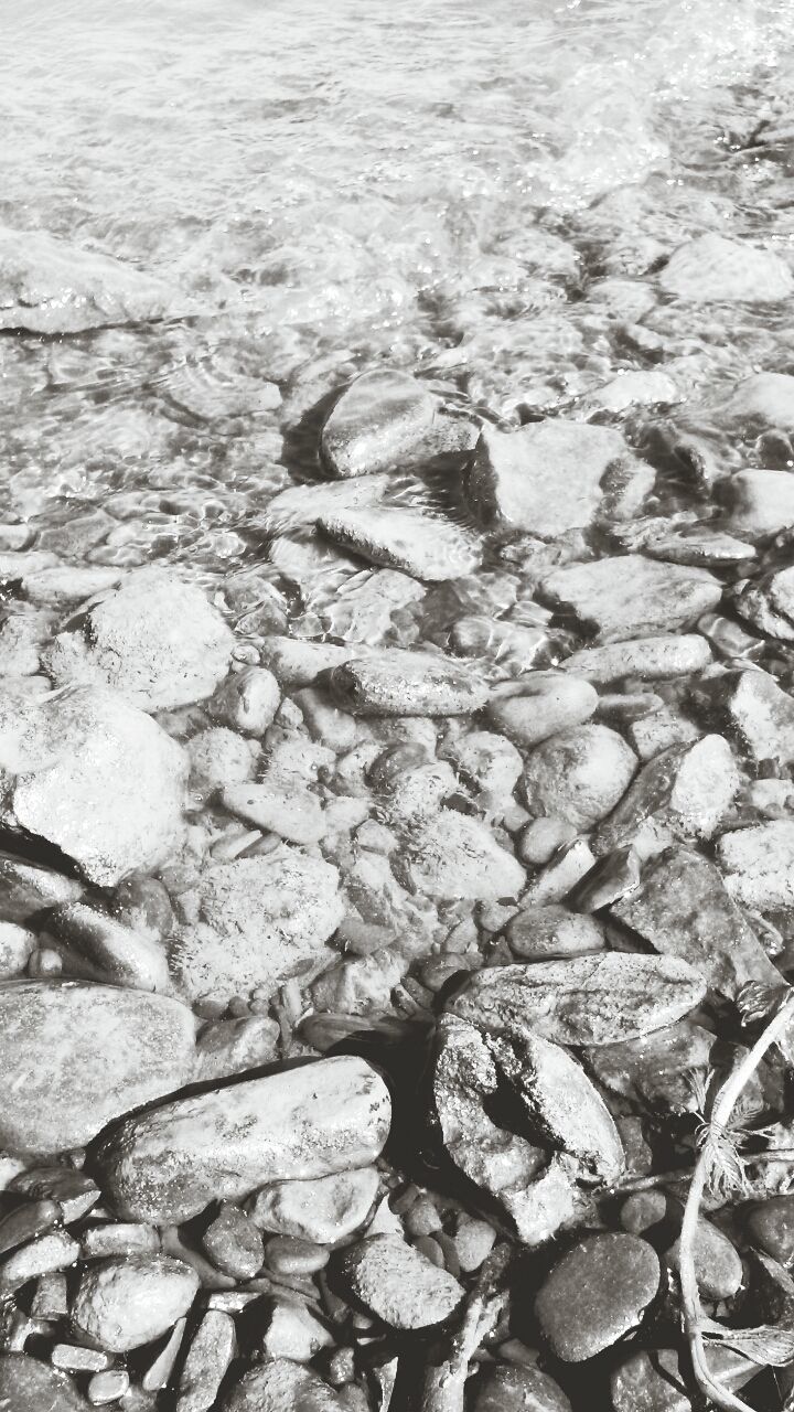 water, high angle view, full frame, nature, backgrounds, textured, stone - object, rock - object, beach, day, tranquility, outdoors, pebble, no people, shore, beauty in nature, pattern, abundance, sea, stone