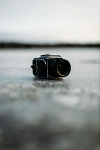 Close-up of camera on table against sky