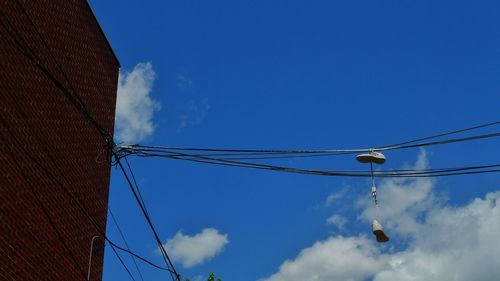 Low angle view of cables against blue sky