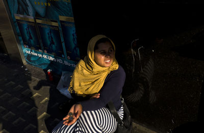 Portrait of smiling man standing at night